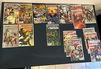 Overview of all 19 comic books laid out on a flat surface showing front covers