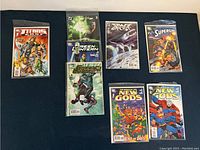 Overview photo of eight DC Comics comic books including Green Lantern 1-3, Death of the New Gods 1-2, Superman, Supergirl, and Teen Titans Special 1.