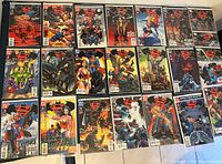 Photo showing a wide view of 21 Superman/Batman comic books arranged in three rows with vibrant cover art featuring various DC superheroes.