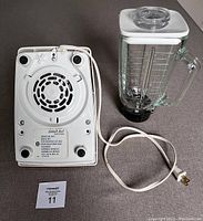 Bottom view of the blender base showing model number and power cord.