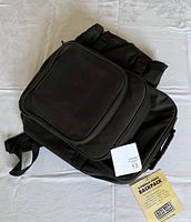 Closed black picnic backpack with attached label visible
