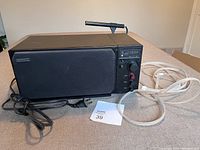 Side angle shot of the Proton 300 radio showing antennas, power cords and front control area.