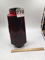 Full view of the tall red and black P. S. Gerzkeramrk ceramic vase with a 12-inch ruler at base showing scale of approximately 14 inches tall.