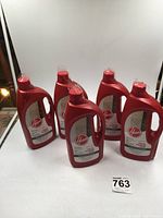 Five red bottles of Hoover Multi Floor cleaning solution arranged on a white surface.