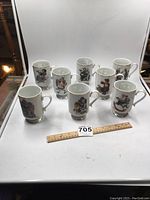 Set of eight Norman Rockwell mugs arranged in two rows with a ruler for scale.
