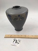 Front view of the blue Roseville pottery vase with Victorian motif and measuring tape showing approximate size.