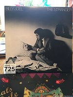 Front cover of Billy Joel's The Stranger vinyl LP album showing artist and symbolic cover art.