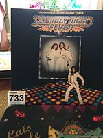 Front cover of Saturday Night Fever original movie soundtrack vinyl album with disco graphics and Bee Gees photograph.