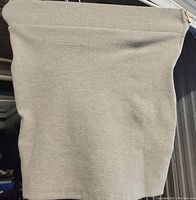 Photo of one grey ribbed skirt folded and showing texture and side zipper.