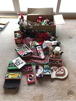 Overall box and items spread out showing variety of Christmas decor and games