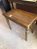 Front angled view of wooden hall bench showing overall shape, color, and leg design
