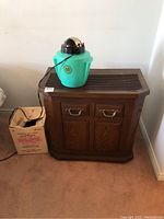 Kenmore variable speed humidifier cabinet with faux wood finish and vintage HanksCraft steam vaporizer on top near wall corner.