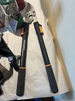 Photo of Fiskars pruning shears showing full length of the tool including handles and cutting blades on a white surface.