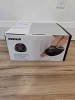 Closed box of Nekteck Shiatsu Foot Massager displaying product image and branding.