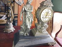 Full front view of clock and attached figure on base