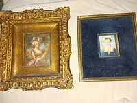 Photo of two miniature paintings side by side, one ornate gilt frame with Marie Antoinette gouache, one blue velvet frame with miniature watercolor portrait.