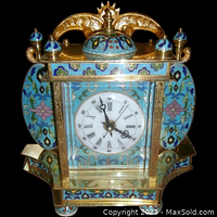 Front view showing Roman numeral dial, gilt brass frame and cloisonne enamel floral panels