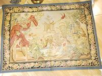 Full view of the French wool tapestry showing garden scene with birds, floral border, and blue edge.