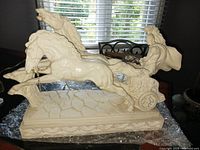 Front view of full statue showing gladiator, horses, chariot and base