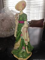 Front view of the Royal Doulton Sarah Bernhardt figurine showing full figure in green dress with pink accents
