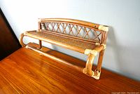 Front diagonal view of the vintage bamboo rattan wall shelf showing woven rattan shelf, bamboo frame with lattice detail, and rounded bamboo edges with rattan binding.