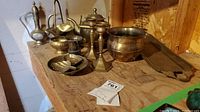Overall view of assorted brass pieces on wood surface