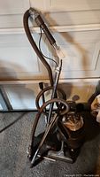 Full view of Filter Queen vacuum with hose, wand, and canister body in garage setting