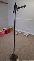Full view of antique cast-iron floor lamp frame showing the height and base condition.