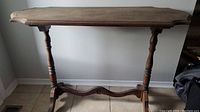 Front view of vintage wooden hall table showing top and legs