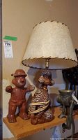 Photo showing both the MCM poodle lamp with fiberglass shade and South American figurine on a wooden shelf, illustrating size and details.