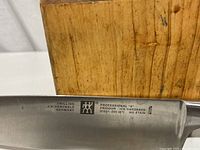 Close-up of the chef's knife blade with brand and model markings showing Professional 'S' Friodur Ice Hardened No Stain, 31021-200 8.5" by J.A. Henckels Zwilling Germany