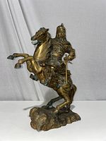 Front view of solid brass Genghis Khan statue mounted on a rearing horse, showing detailed armor and facial features.