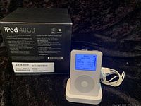 Front view of iPod docked with box behind