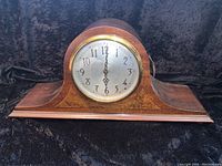 Front view of Seth Thomas electric mantel clock showing wood case and closed glass face