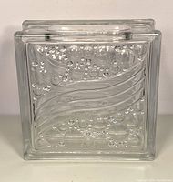 Front view of vintage glass brick vase showing raised bubble and wave textured glass