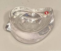 Top and side view of clear art glass candle holder showing shape, thickness, and Iittala label.
