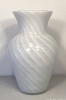 Front view of the opaque white Murano glass vase showing the swirl pattern and the flared lip.