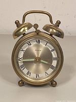 Front view of vintage Blessing dual bell alarm clock showing full clock face and body.