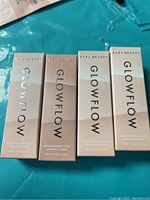Photo of four unopened Glowflow Highlighter Stick boxes by Kara Beauty showing front packaging and branding.