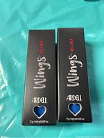 Two boxed Ardell Wings Gel Eyeliners in blue, showing front packaging with brand and product names.