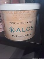 Photo of unopened Kalos pine scented hair removal wax in 400g plastic container.