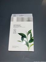 White box packaging of Beautygreen antioxidant face masks with green tea essence, showing front label and green tea plant graphic.