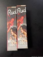 Two boxed Rude Magic Duo Highlighter and Contour products with identical design and Medium shade label.