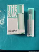 New, unopened Solinotes Paris The Blanc Eau de Parfum 50ml box with clear glass spray bottle next to a small roll-on bottle in branded packaging.