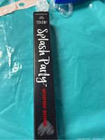 Front side of the mascara box showing 'Splash Party Waterproof Mascara' in white and red text on black background.
