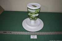 Green Catit Senses 2.0 Food Tree interactive cat feeder with spiral openings on round white base.