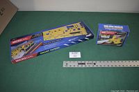 Photo showing MicroDial Smart Tapers tapering jig box and the GRR-Ripper push block box with a ruler for scale and lot tag.