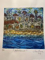 Close-up photo of 'Habana' signed print by Vantour showing colorful coastal scene with buildings and water