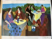 Full color print showing five women seated around two small tables with vases of flowers and teapots, surrounded by greenery.