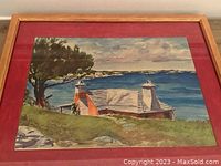 Frontal view of the framed watercolor painting illustrating the coastal houses, tree, and ocean scene.